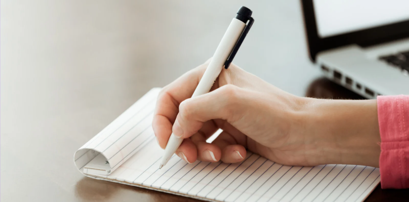 Hand with pen about to make notes